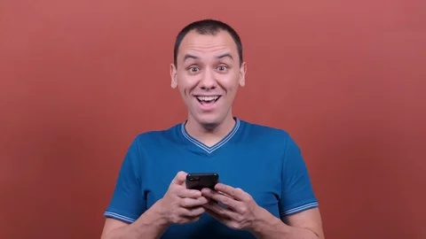 Man Looking surprised wow, using mobile cell phone. Stock Footage 123017466