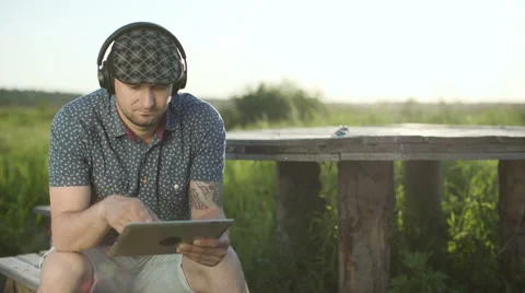 Man looking tablet and listening to music Stock Footage 68354017
