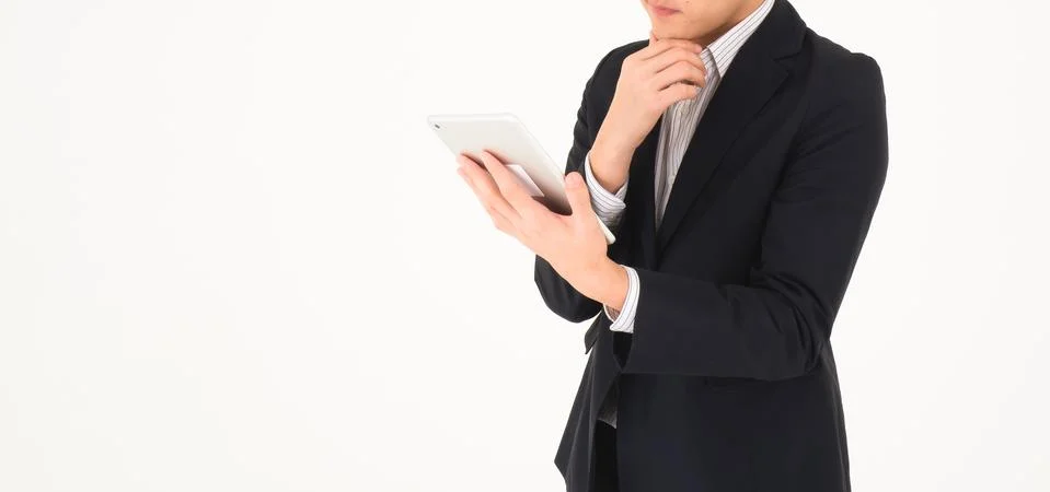A man looking in tablet and thinking. Stock Photos