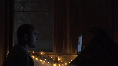 A man looking at the tablet in a dark room. A medium shot of the cinematic Stock Footage 146909088