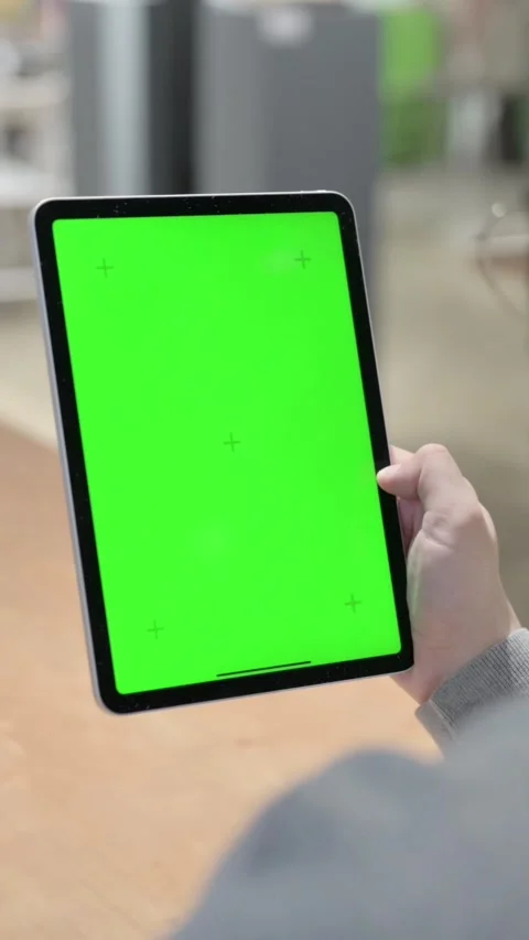 Man Looking at Tablet with Green Chroma Screen, Vertical Video Stock Footage 339581181