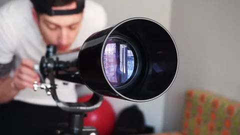 Man looking in telescope in slow motion Stock Footage 86683000
