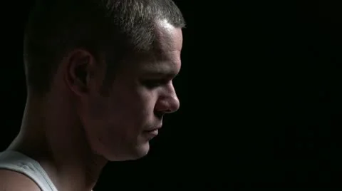 Man looking up, then at camera, then smirking Stock Footage 11451491