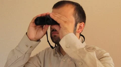 Man looking through binoculars Stock Footage 65813463