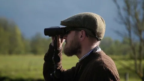A man looking through binoculars Video stock 73451100