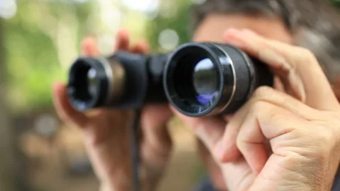 Man looking through binoculars Stock Footage 119599328