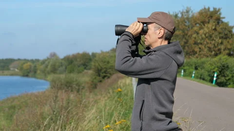 Man is looking through the binoculars Stock Footage 138141986