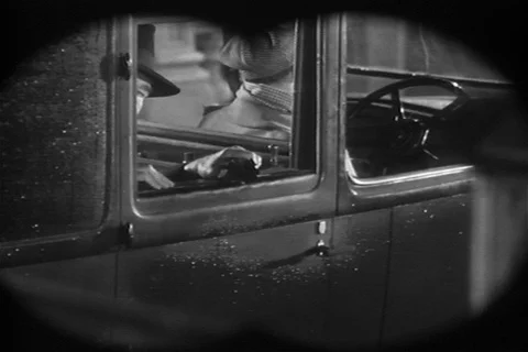 Man looking through binoculars at license plate, 1940s Stock Footage 90762253