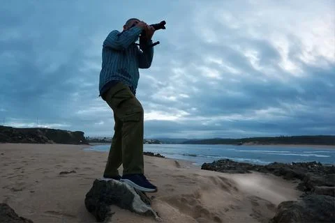 Man looking through binoculars Stock Photos