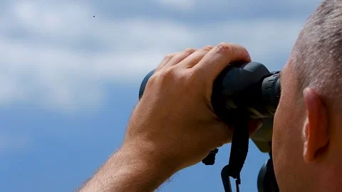Man looking through binoculars at the sky. Stock Footage 341109740