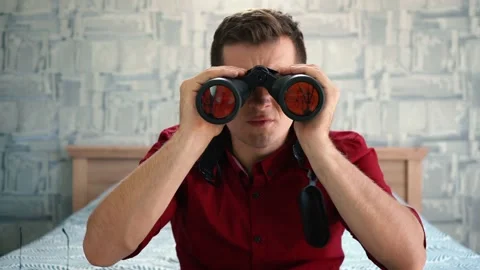 Man looking through binoculars is surprised 스톡 동영상 140651975