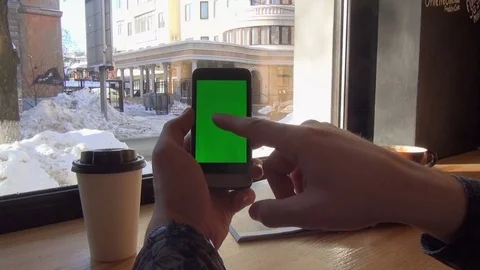 Man looking through green screen pages on smartphone Stock Footage 74228645