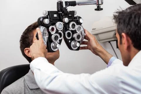 Man looking through the keratometer 写真素材