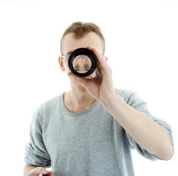 Man looking through a lens Stock Photos