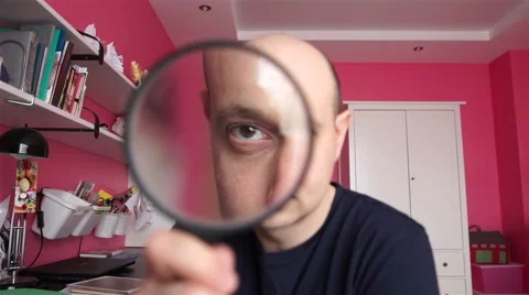 Man looking through a magnifying glass Stock Footage 60036621