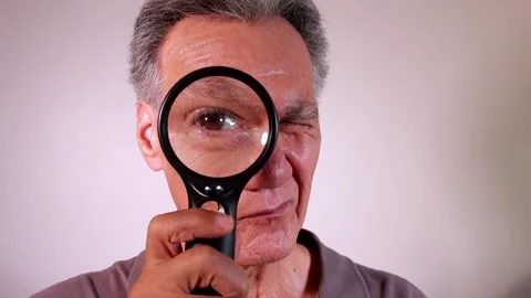 Man looking through a Magnifying Glass Stock Footage 264583907