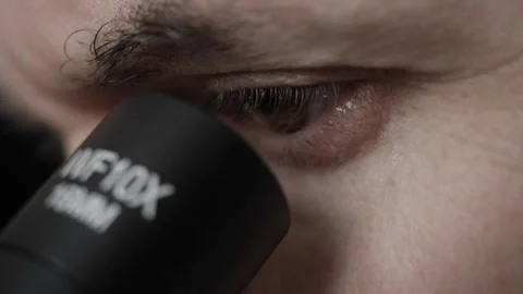 Man Looking Through Microscope Eyes Closeup Scientist Science and Medical R.. Stock-Footage 285411807