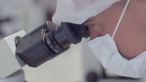 Man looking through a microscope Tilt Down Stock-Footage 75165271
