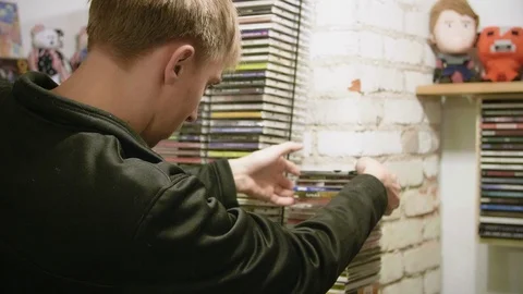 Man Looking Through a Stack of CDs at Flea Market Stock Footage 104690609