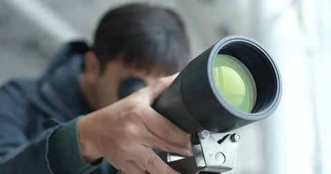 Man looking through telescope to observe the bird habitat Stock Footage 85559986