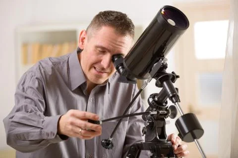 Man looking through telescope Stock Photos