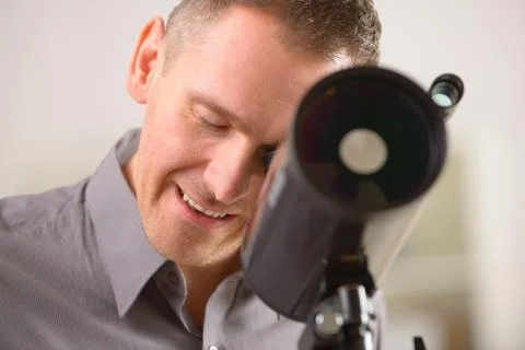 Man looking through telescope Stock Photos
