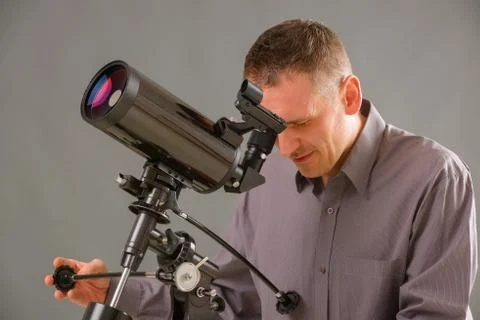 Man looking through telescope Stock Photos