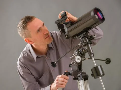 Man looking through telescope Stock Photos
