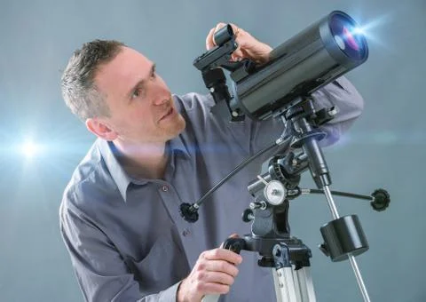 Man looking through telescope Stock Photos