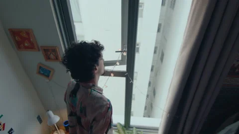 Man Looking Through the Window from His Bedroom Stock Footage 235659261
