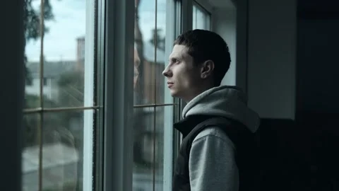 Man Looking Through Window on Rainy Day. Disappointed Mood and Bad Weather Stock Footage 309912380