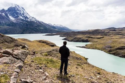Man looking toward awesome view of Torres del Paine mountain range Stock Photos