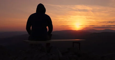 Man looking toward burning sunset sky and panoramic view of mountain hills Stock Footage 139767671