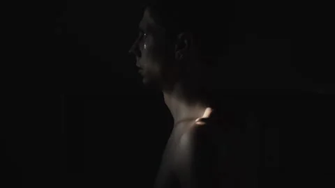 Man looking toward sunlight in dark bathroom, emotional struggle and cinematic Video stock 347302513
