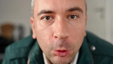 Man looking towards camera, talking and smiling, close up Stock Footage 220050808