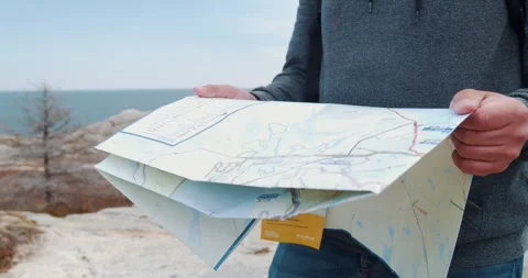 Man Looking the Travel Route on a Map in the Mountain. Stock Footage 248064834