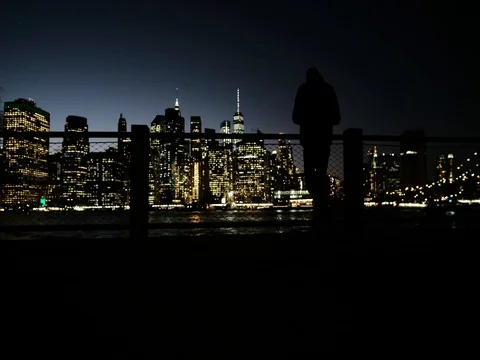 Man looking at view of Manhattan at night Stock Footage 81080671