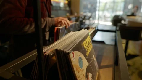 Man looking at vinyl records Stock Footage 277073964
