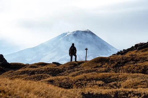 Man looking at the Volcano in a cloudy day in Sicily. 스톡 사진