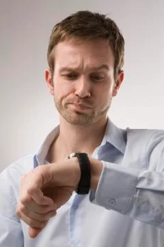 Man Looking at Watch Stock Photos