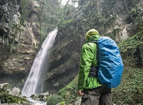 Man looking at waterfall 스톡 사진