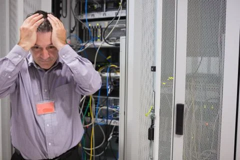 Man looking weary of data servers Stock Photos