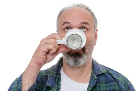Man looking up while drinking morning coffee Stock Photos