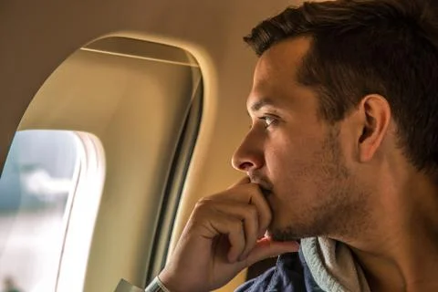 Man looking in the window of the plane Stock Photos