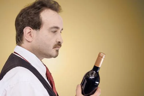 Man looking at wine bottle Stock Photos
