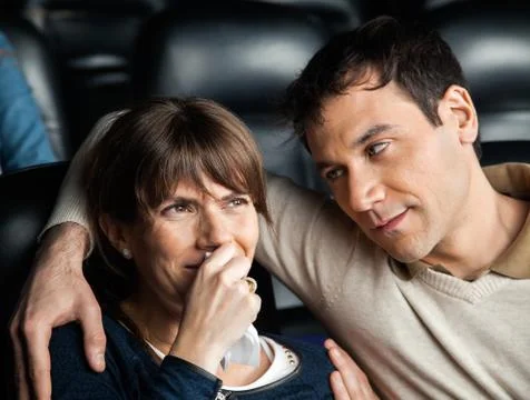Man Looking At Woman Crying While Watching Movie 写真素材