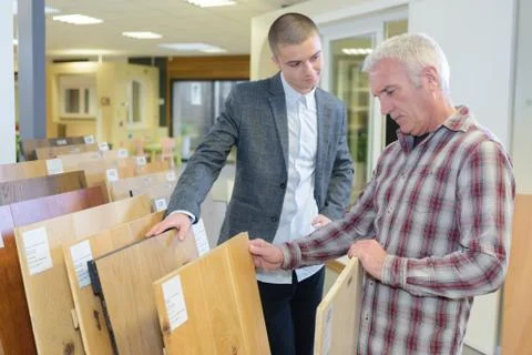 Man looking at wood samples Stock Photos