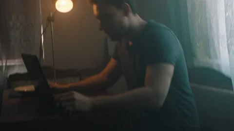 Man looking for work on laptop while sitting at home Stock Footage 131397910