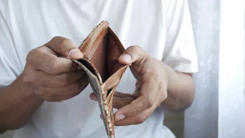Man looks into and showing empty wallet. Inflation money unemployment Bankruptcy Stock-Footage 336450586