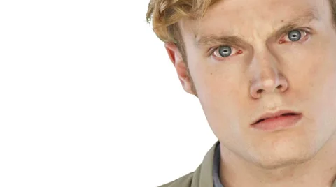 Man looks angry into the camera on a white background Stock Footage 33842229